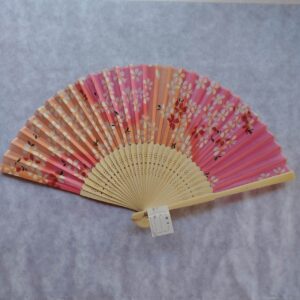 Pink silk Japanese folding fan with white cherry blossoms
